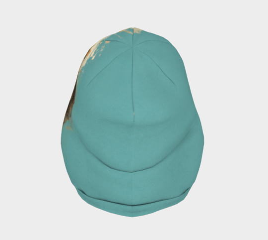 Top view of a teal beanie featuring a vibrant abstract portrait design by Élise Charette