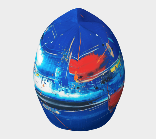 Top view of the abstract blue beanie, highlighting the swirling abstract art in shades of blue, red, and white.