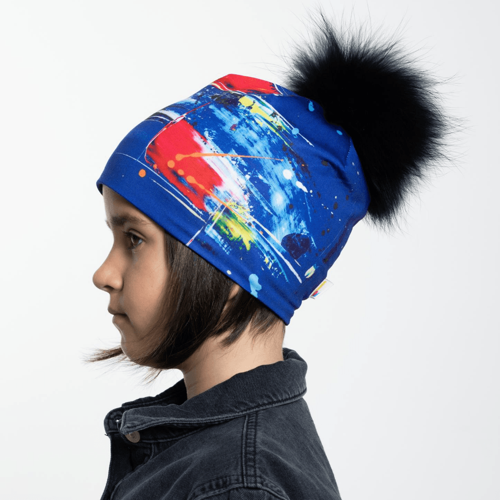 Side profile of a young girl wearing the Abstract Blue Beanie, showcasing the abstract blue pattern.