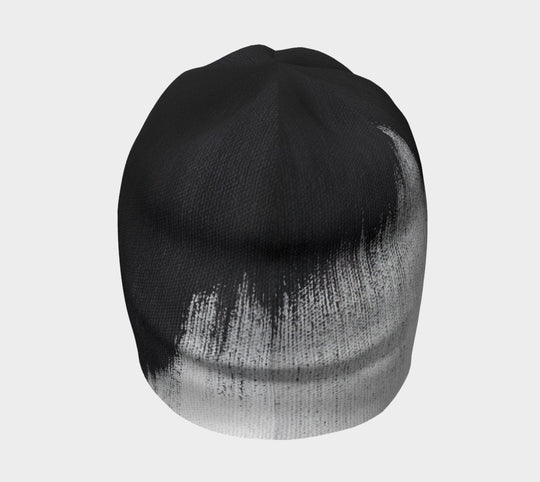 Side view of the beanie highlighting the abstract brush stroke design.