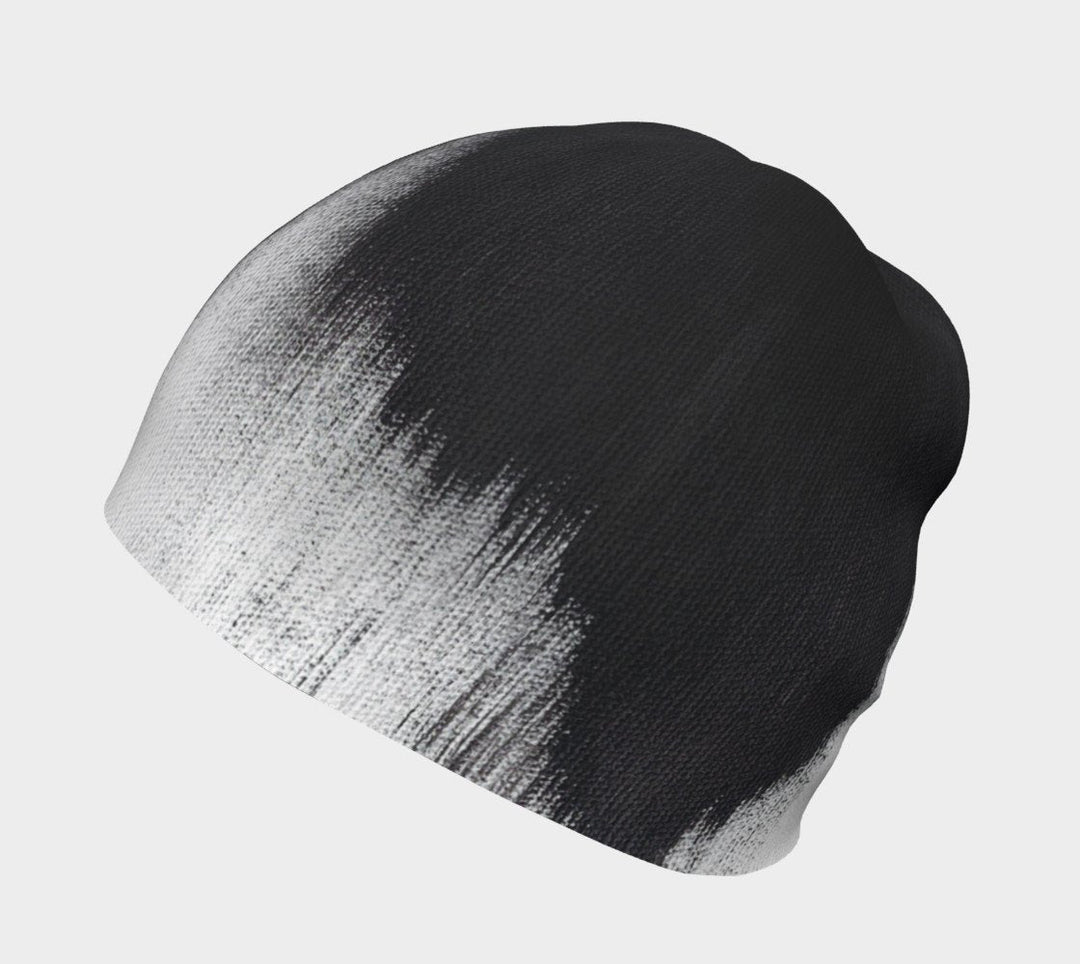 Close-up of the black and white abstract brush stroke pattern on a grey beanie.