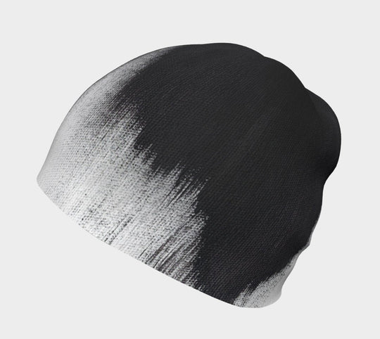 Close-up of the black and white abstract brush stroke pattern on a grey beanie.