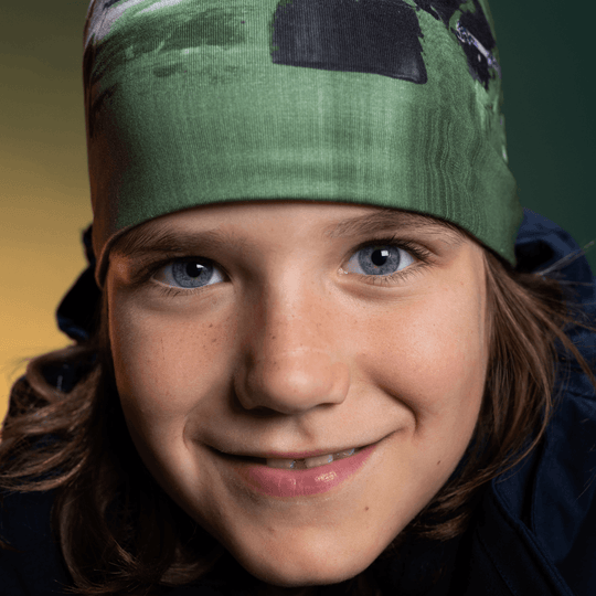 Close-up portrait of a young person wearing the Amazonia green beanie.