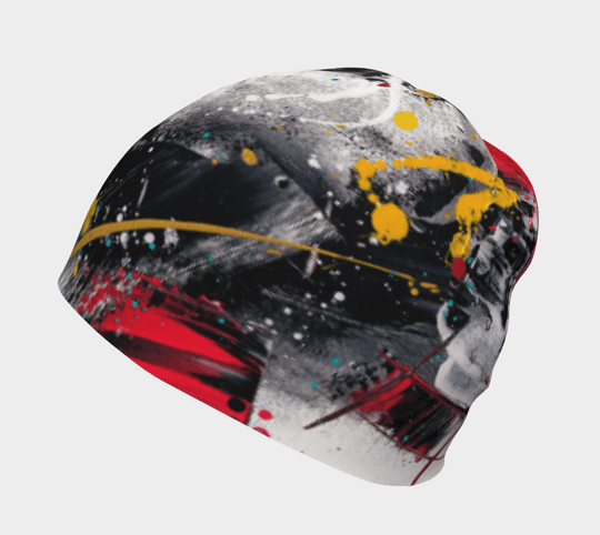 Close-up of a beanie with a black, red, and white abstract paint splatter design.