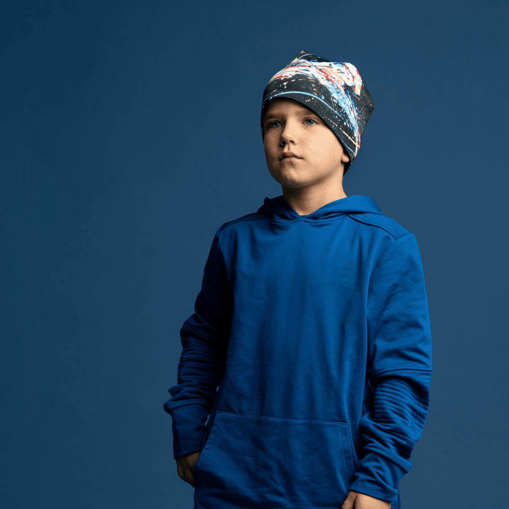 Young boy wearing the Black Horse Beanie, hands in pockets, looking forward.
