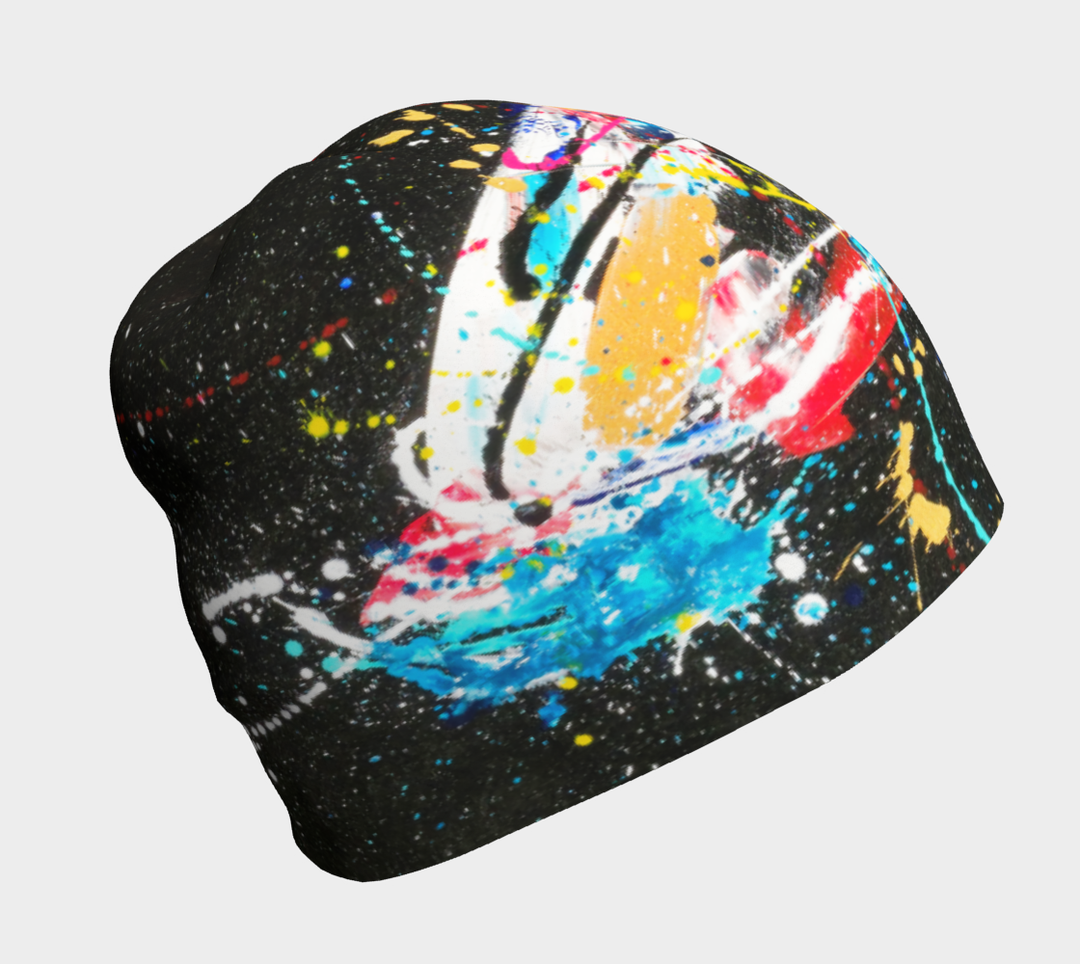 Close-up of a black beanie with a dynamic, colorful abstract paint splatter design.
