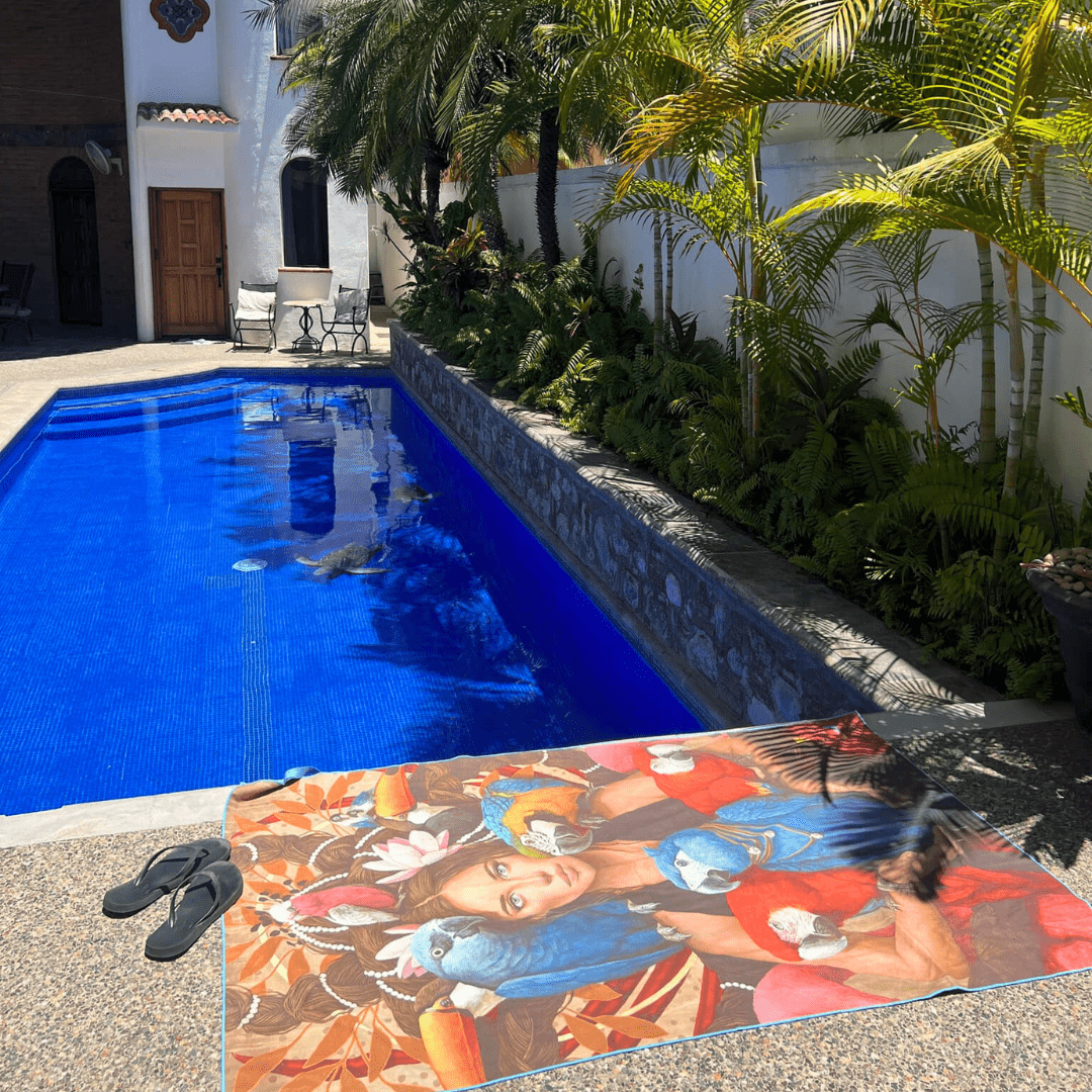 BLU XL Reversible Microfiber Towel laid out beside a bright blue swimming pool.