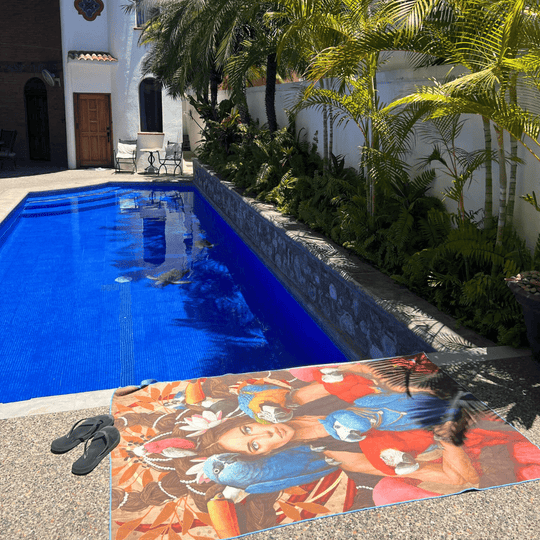 BLU XL Reversible Microfiber Towel laid out beside a bright blue swimming pool.