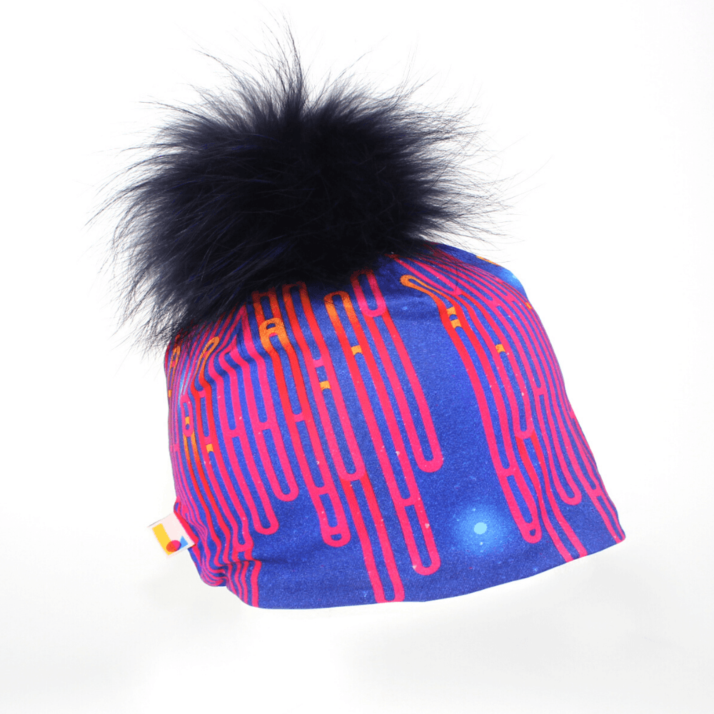Blue Loops Beanie with a large navy blue pompom against a white background.