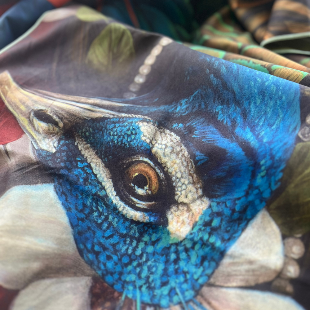 Detailed close-up on the face of the peacock artwork featured on the Chrysalide artistic beach towel.