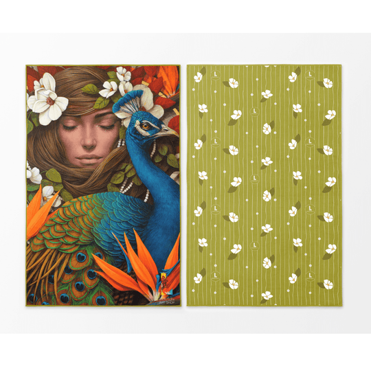 Front and back view of the Chrysalide reversible beach towel featuring a peacock and floral art on one side and a green floral pattern on the other.