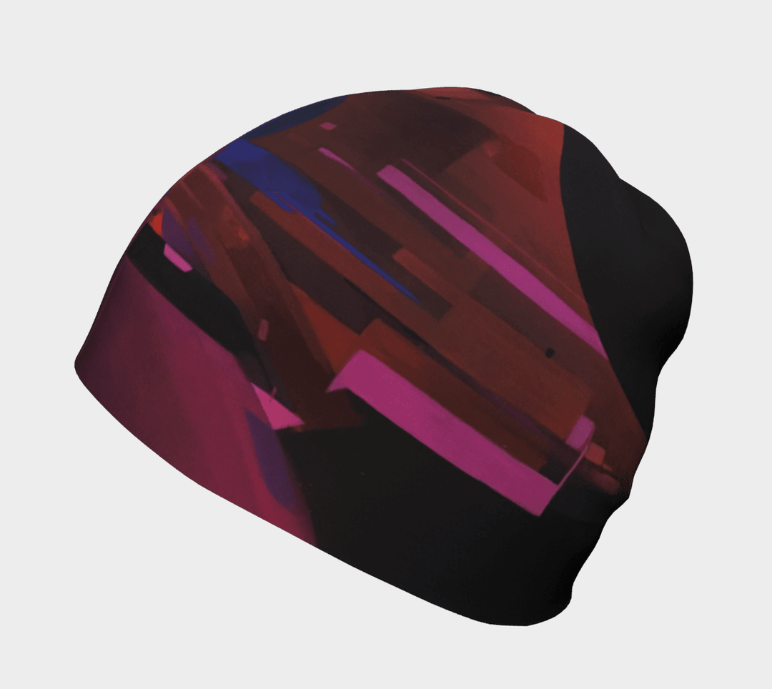 A close-up view of the City Beanie, showcasing its abstract red, pink, and blue geometric pattern on a black background.