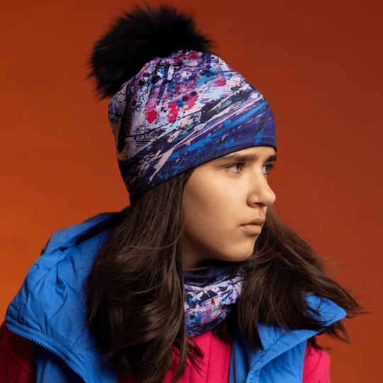 Young person wearing a beanie and neck tube with abstract &