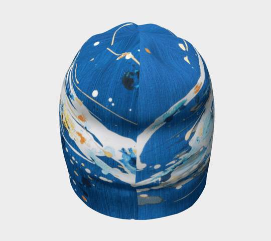 Top view of the blue abstract art beanie, showcasing the dynamic paint-like pattern.