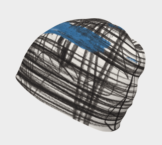 The Expressive Sketch Beanie laid flat, showcasing its abstract black and blue design.