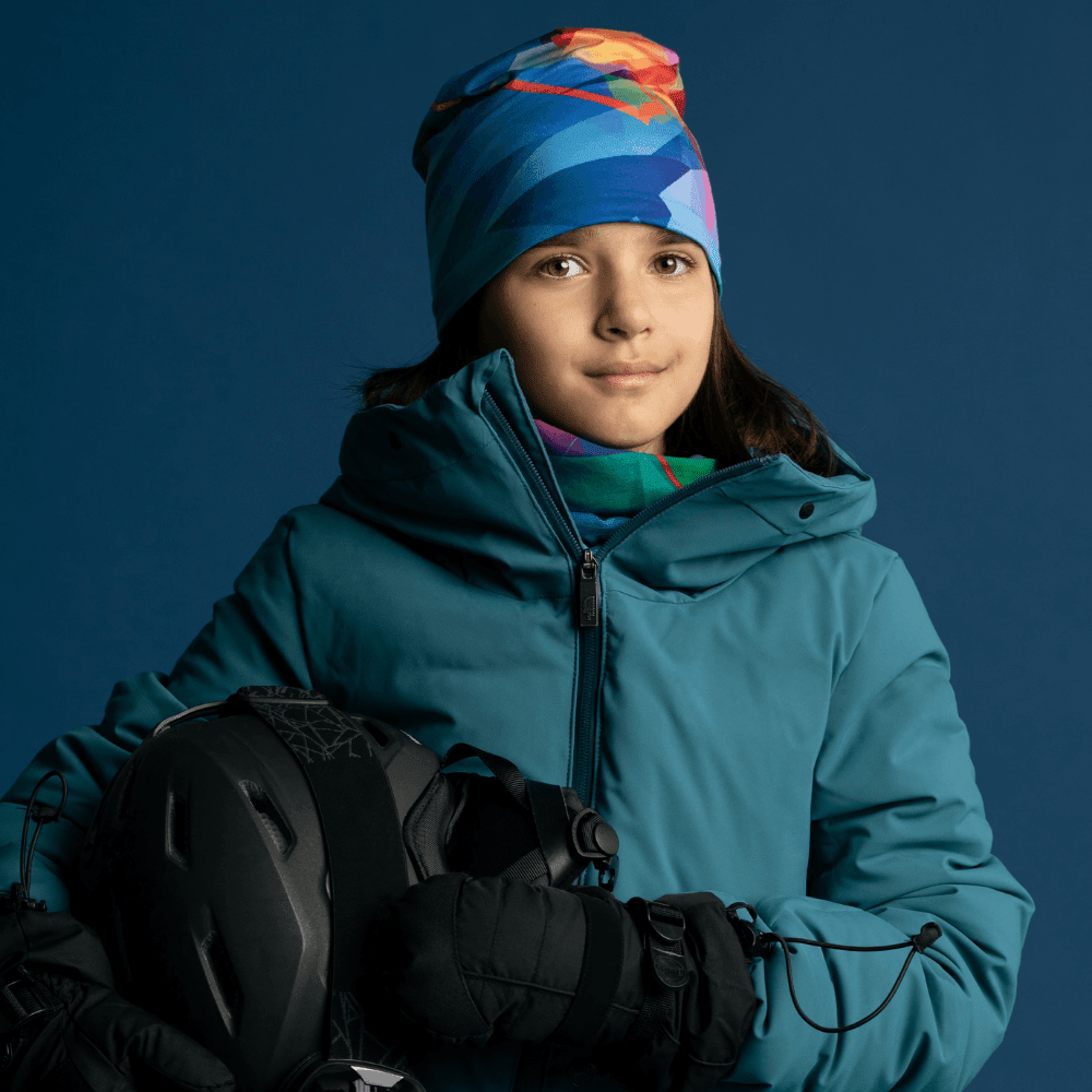 Young girl wearing a teal winter jacket and a matching &