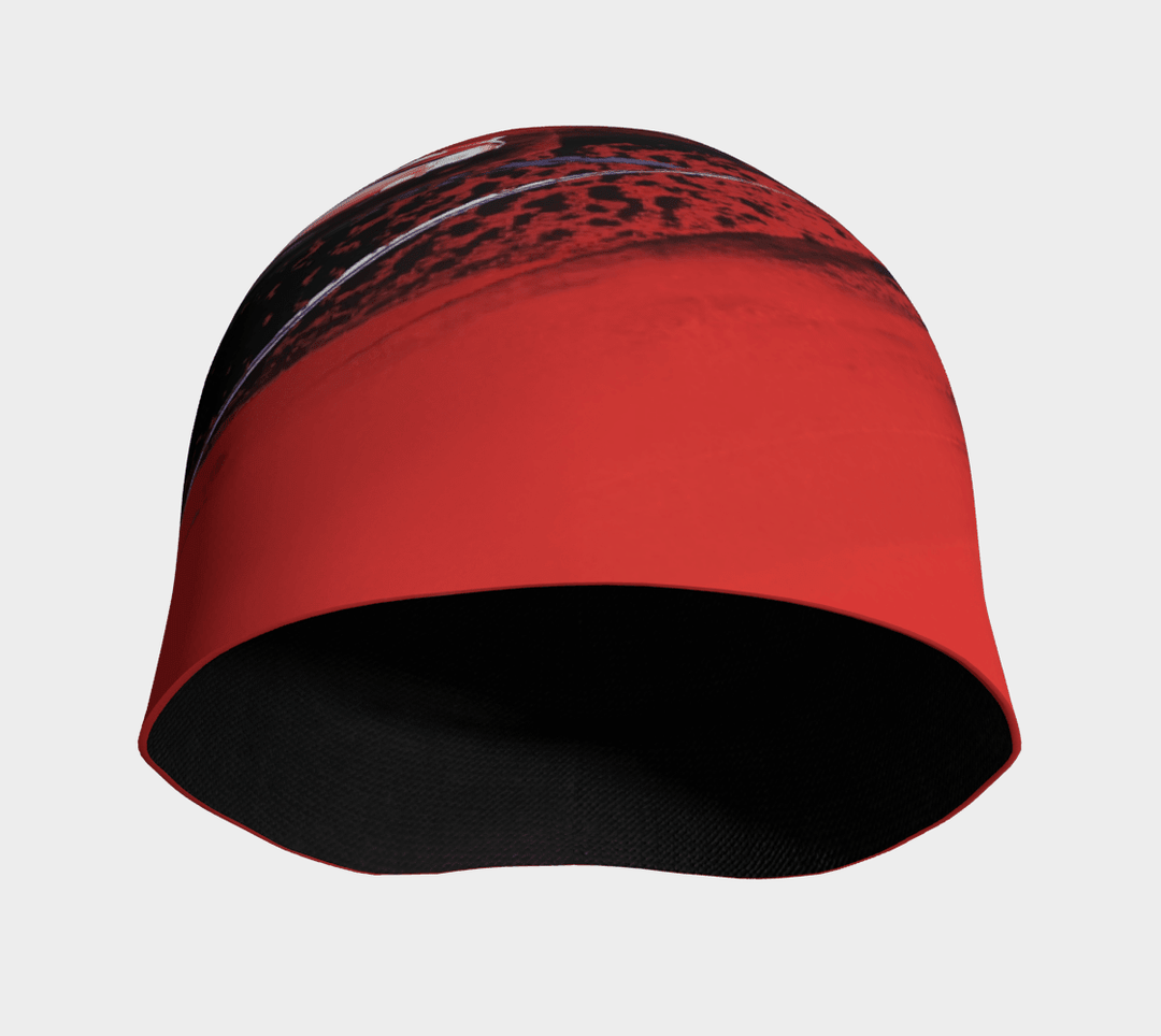 Red abstract art beanie with black lining visible, shown from the front opening.