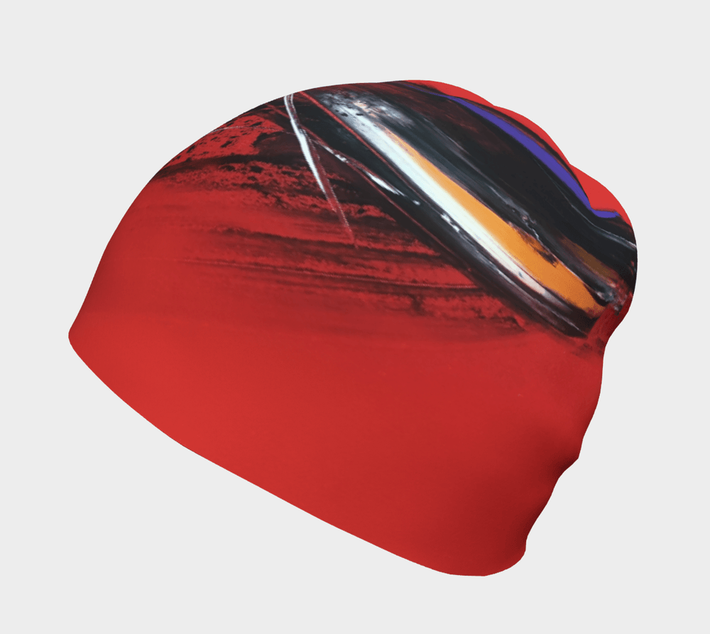Red abstract art beanie with black, white, and blue brushstrokes, angled view.