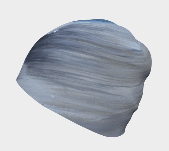 Side-back view of the Golden Sea Beanie, highlighting the flowing abstract art pattern.
