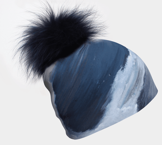Blue and white abstract painted Golden Sea Beanie with a fluffy black pompom.