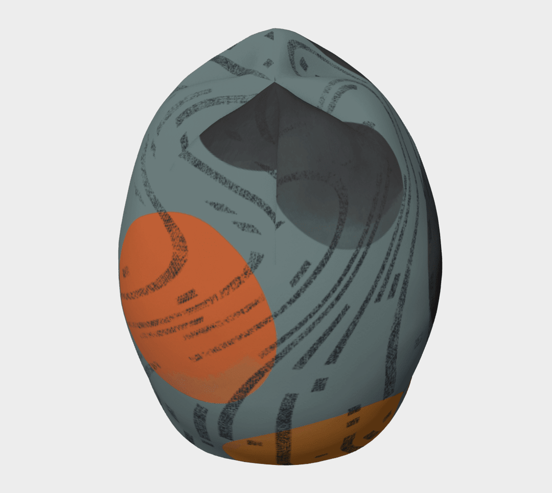 Side overhead view of the beanie showing full wrap-around orange circle and swirling black mark pattern