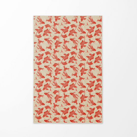 The reversible side of the Guerrière Pacifique towel, displaying a repeating pattern of red koi fish on a beige background.