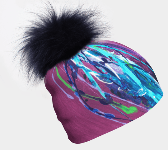 Close-up of the Hope Beanie with Pompom, showcasing its vibrant abstract print and fluffy black pompom.