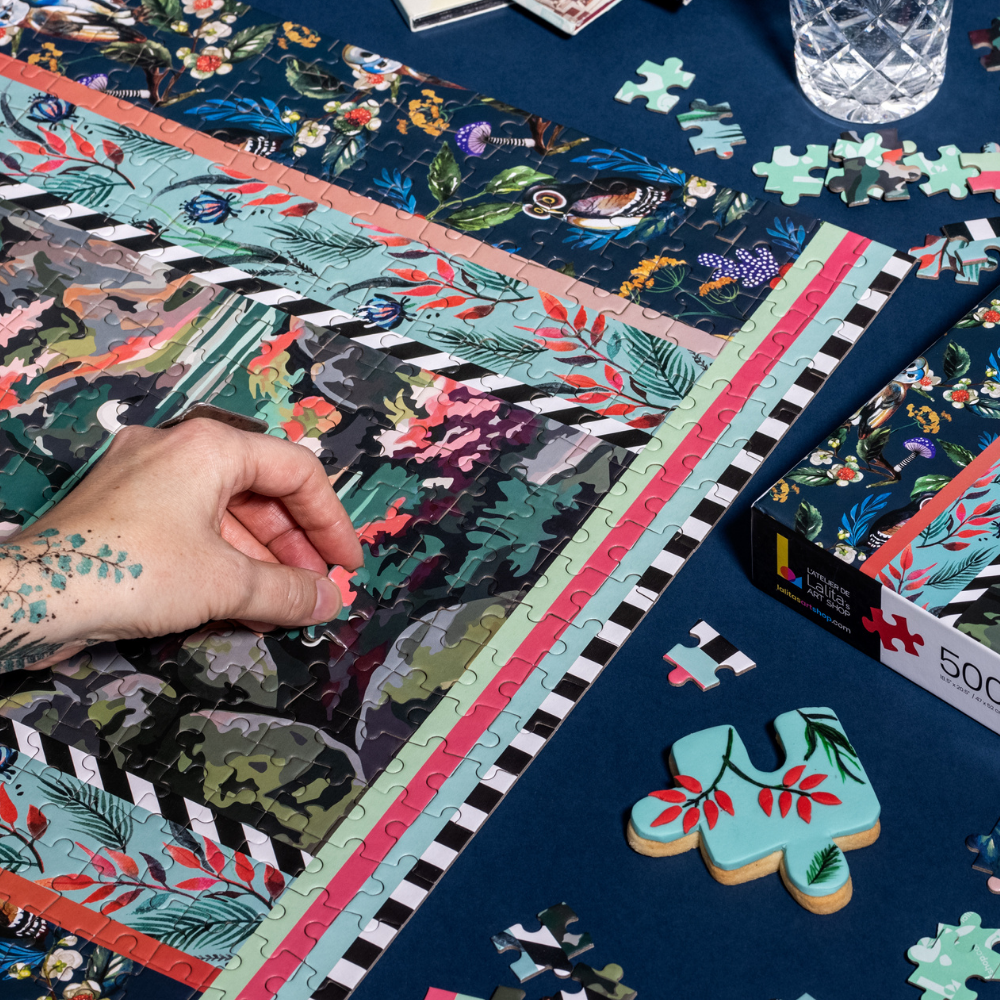 Close-up of a hand placing a puzzle piece into the Jigsaw Puzzle "Flying High" image.