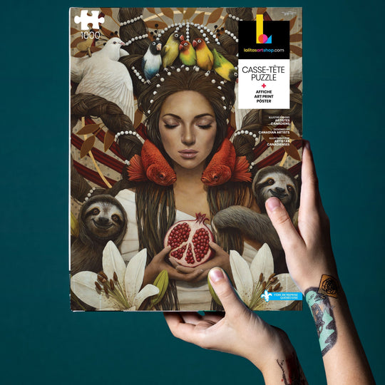 Hands holding the "Guerrière Pacifique" 1000-piece jigsaw puzzle and a signed art print.
