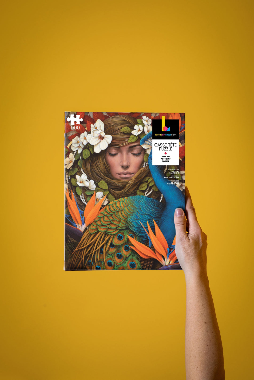 Hand holding the "Le Chrysalide" 500-piece jigsaw puzzle box, showcasing the detailed artwork.