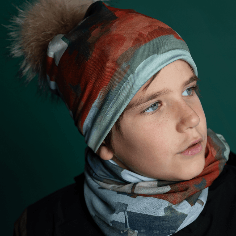 Young boy wearing the Lachine Beanie and matching neck tube, looking to the side.