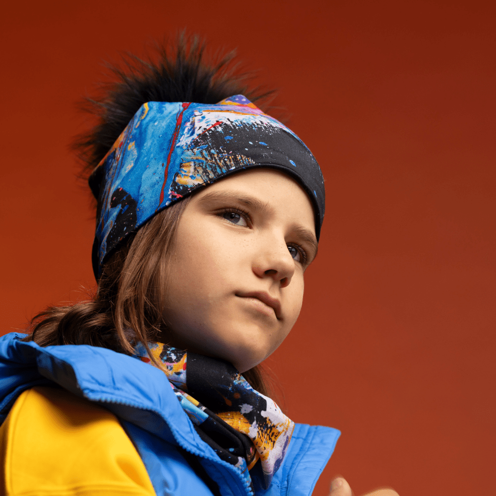 A young person wearing the MatriX Beanie and matching neck tube, looking to the side with a thoughtful expression.