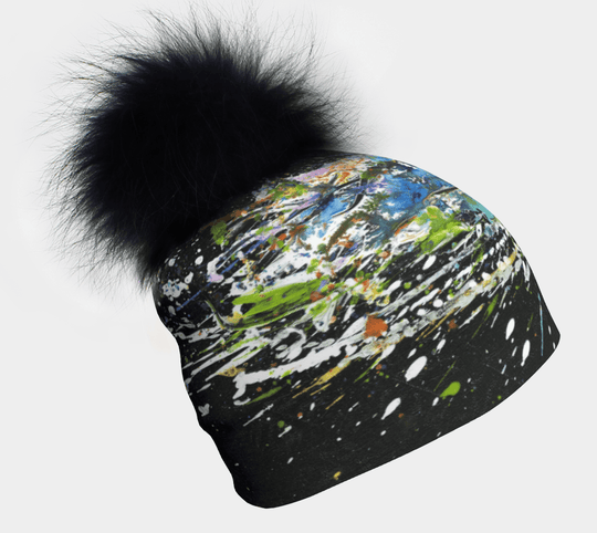 Close-up of Meduse Beanie with a black fur pompom and abstract art print.