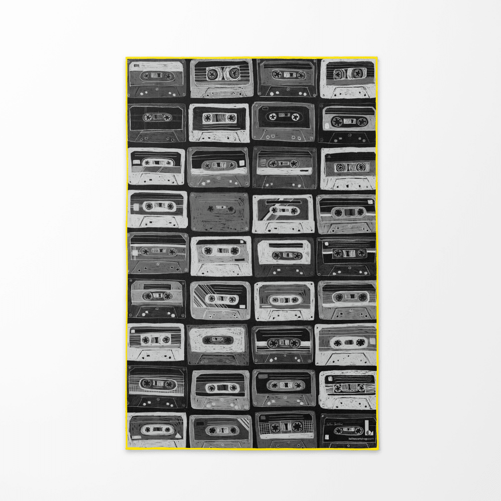 Close-up of the black and white cassette tape pattern on the Mixtapes beach towel.