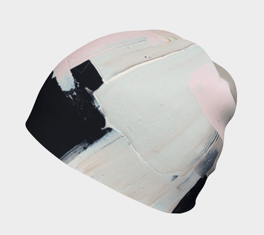 Angled view of the modern quilt beanie showcasing abstract pink and black paint details.