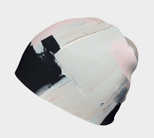 Angled view of the modern quilt beanie showcasing abstract pink and black paint details.