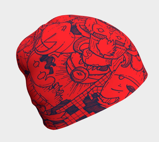 Red beanie with blue cartoon monster doodles, front view.