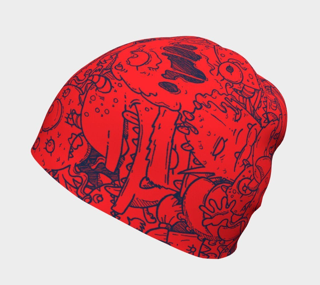 Close-up of the red beanie with blue cartoon monster doodles.