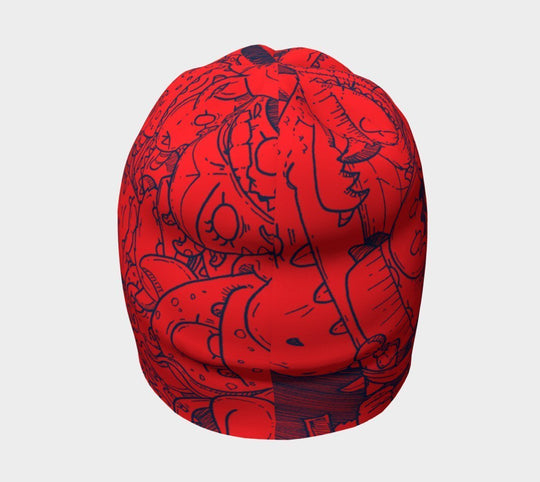 Red beanie with blue cartoon monster doodles, side view.