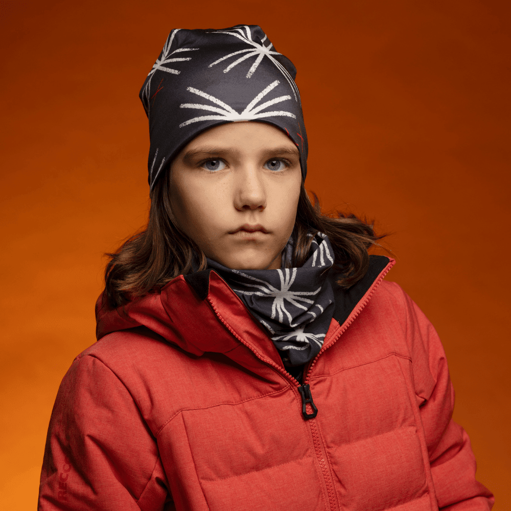 Close-up portrait of a young person wearing the MotifX Black Beanie and neck gaiter, looking at the camera.