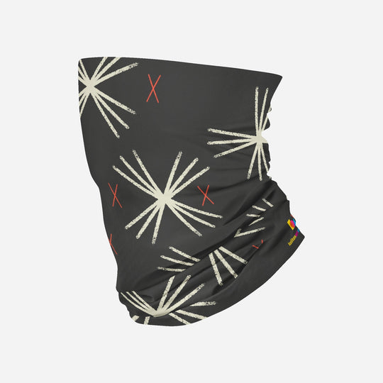 A dark grey multifunctional tube with a cream and red starburst pattern, displayed on a white background.