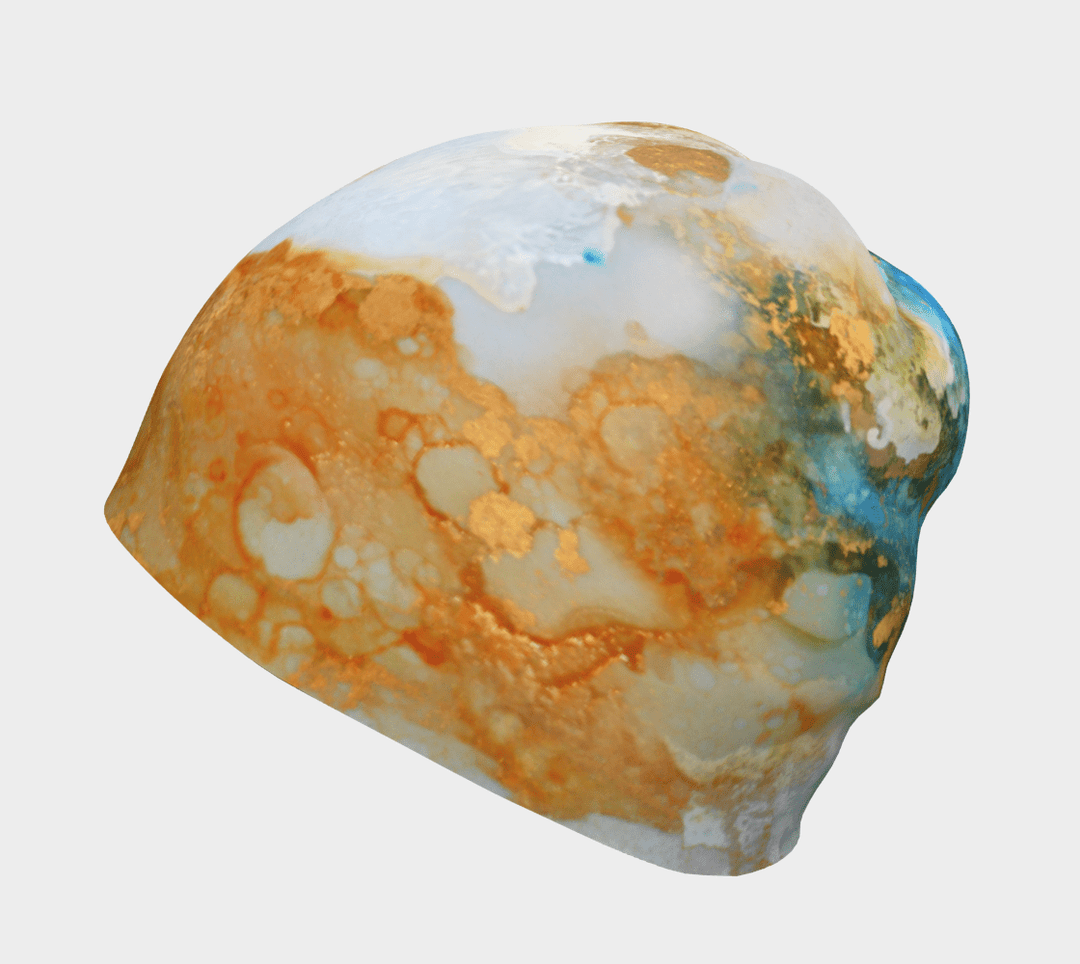 Side view of the Ocean Marble Beanie, highlighting the abstract blue and gold artistic print.