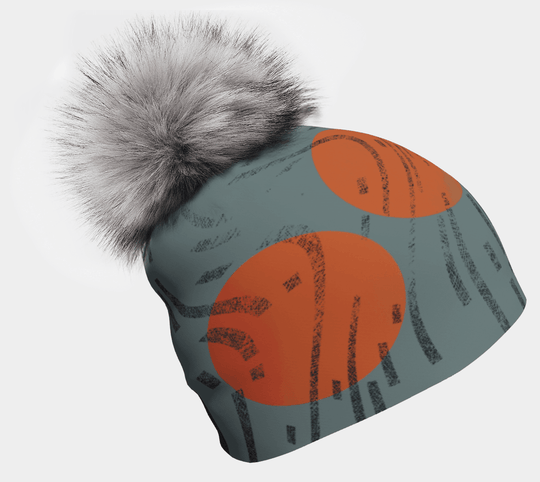 Slate-green and orange-circle pom pom beanie with removable grey fur pom pom, shown as a product render against white background