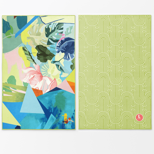 Two sides of a large microfiber towel displayed flat, one with colourful abstract floral art, the other with a green geometric pattern.