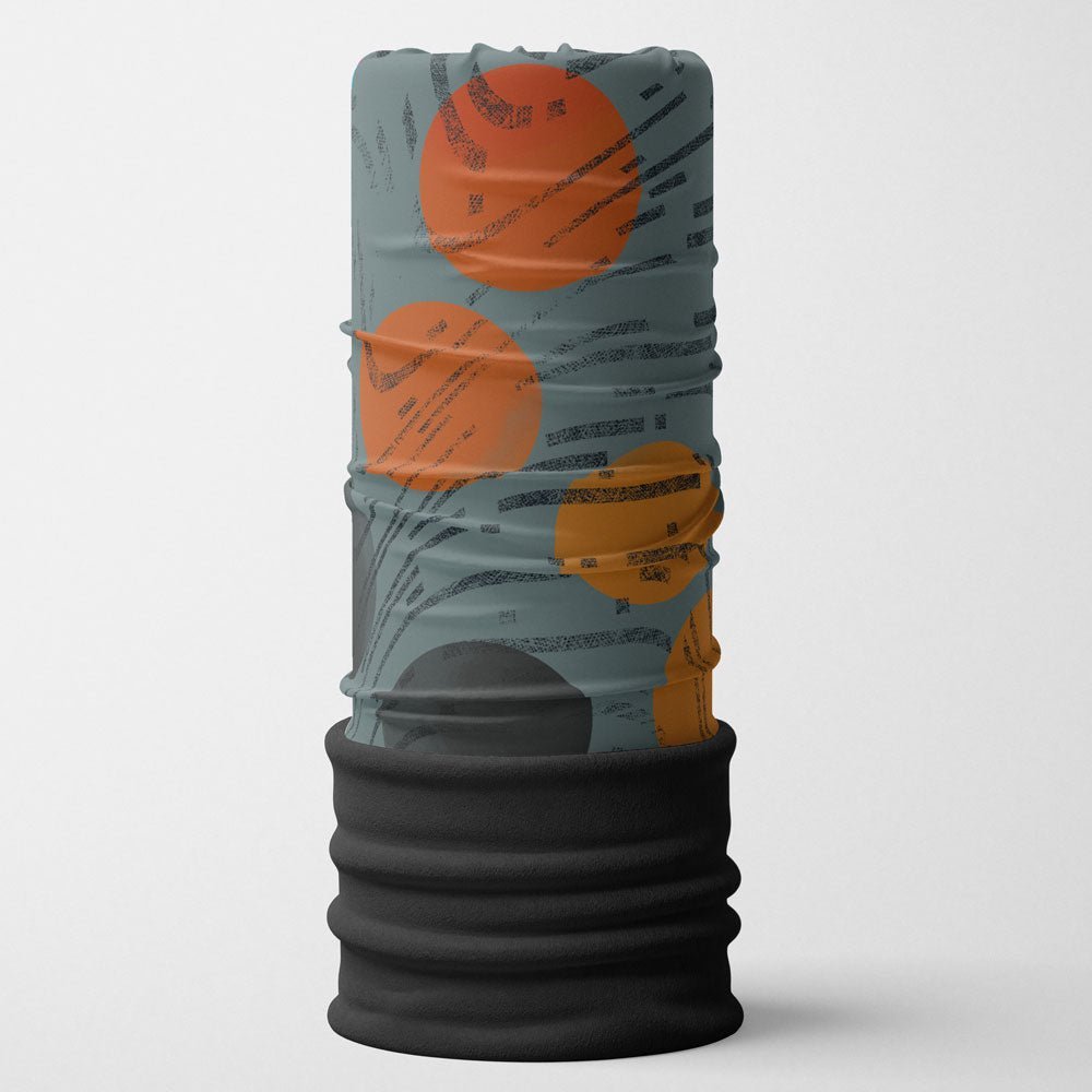 Close-up of a cylindrical tube accessory with an orange and grey abstract design and a black fleece lining.
