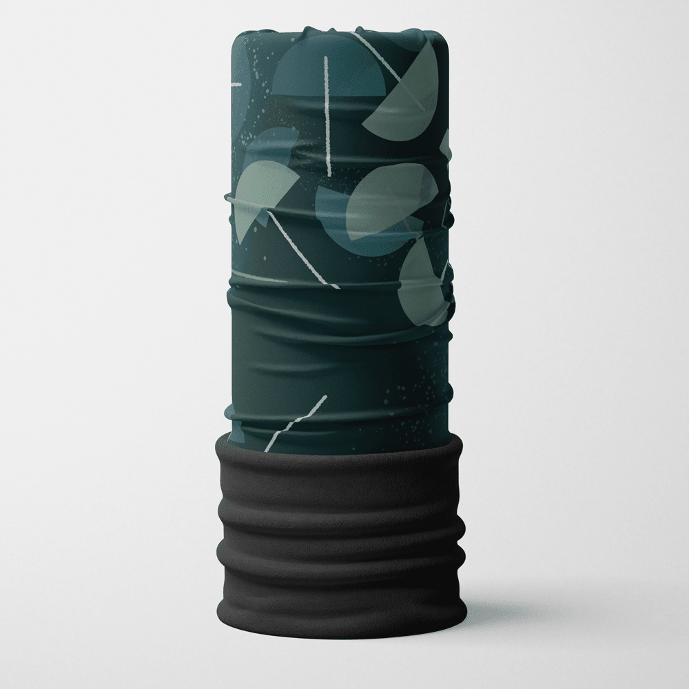 A folded, dark teal and grey abstract patterned neck tube with a black fleece band at the bottom, standing upright against a white background.