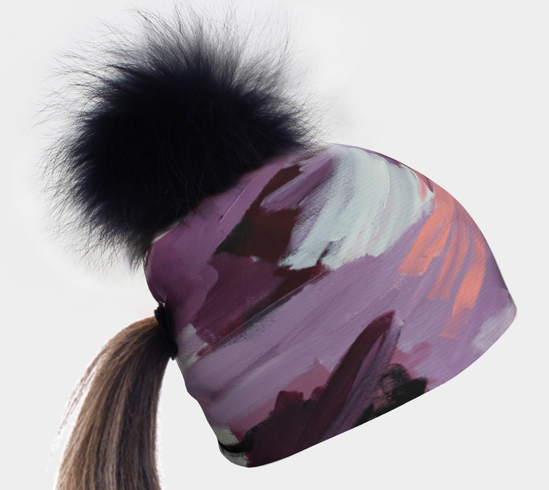 Ponytail Tulips Beanie with a black pompom and a ponytail pulled through the hole.