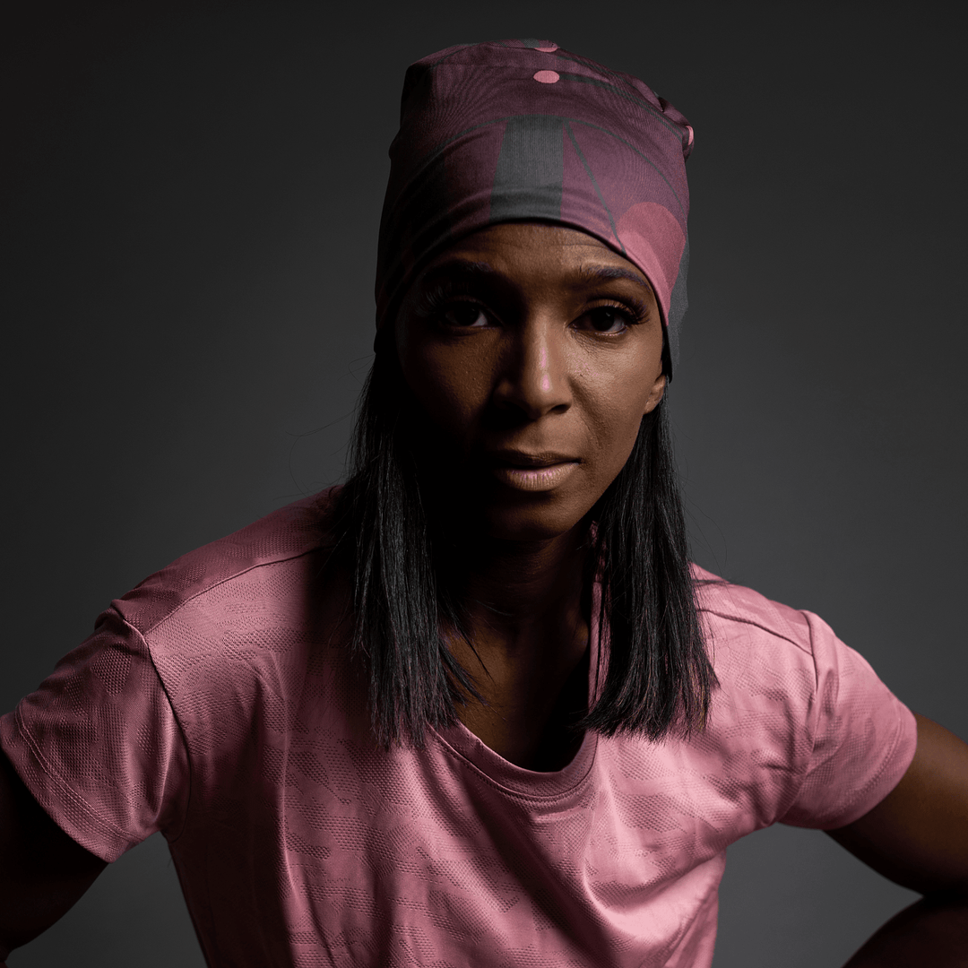 Close-up portrait of a woman wearing a Purple Geometrics Beanie and earrings.