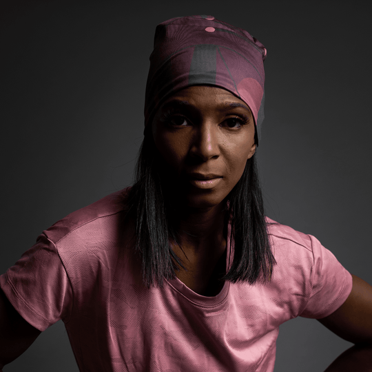 Close-up portrait of a woman wearing a Purple Geometrics Beanie and earrings.