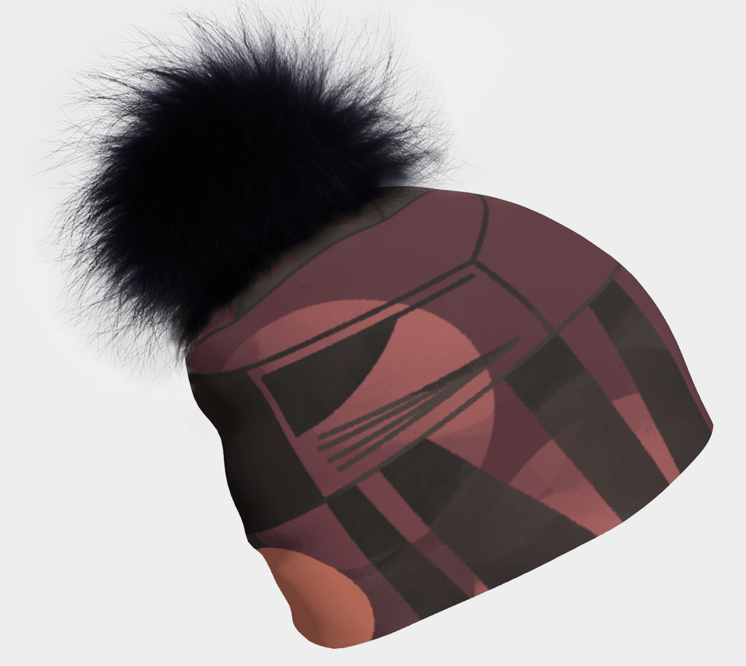 Purple Geometrics Beanie with a fluffy black pompom against a white background.